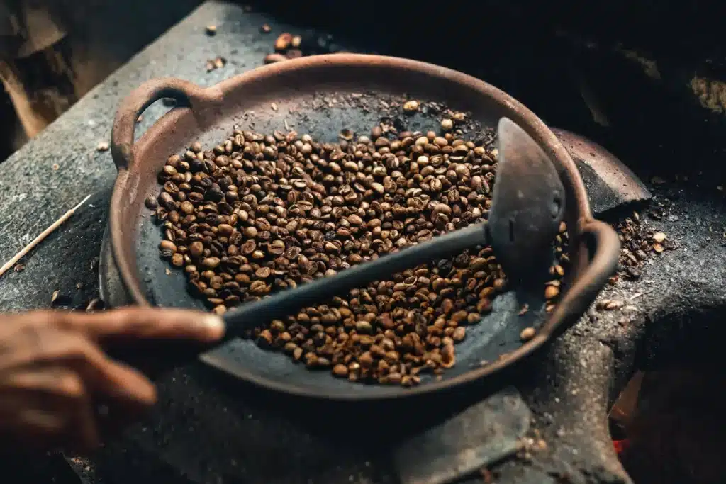 roasting coffee beans in a pen